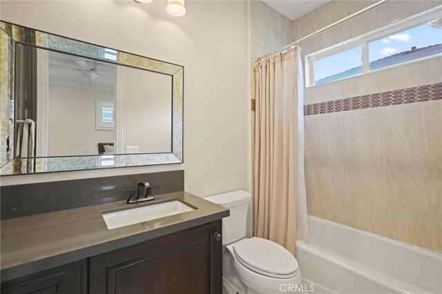 bathroom featuring toilet, vanity, and shower / bath combo
