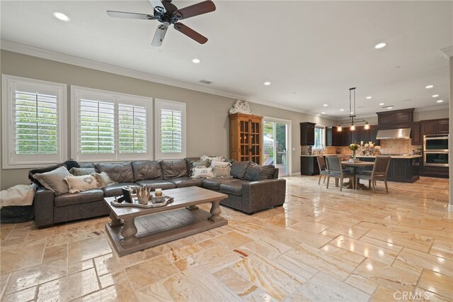 living area featuring recessed lighting, ornamental molding, stone tile flooring, and a ceiling fan