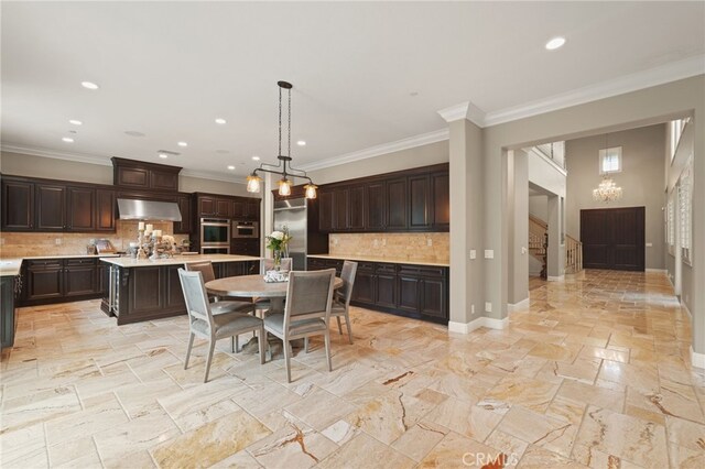 dining room with a chandelier, crown molding, recessed lighting, stone tile floors, and baseboards