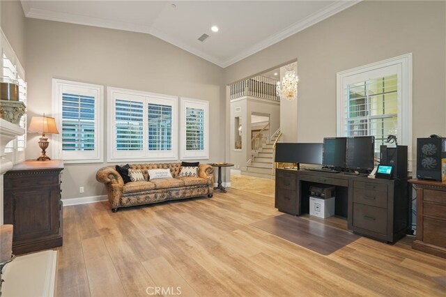 office space featuring wood finished floors, crown molding, a chandelier, baseboards, and vaulted ceiling