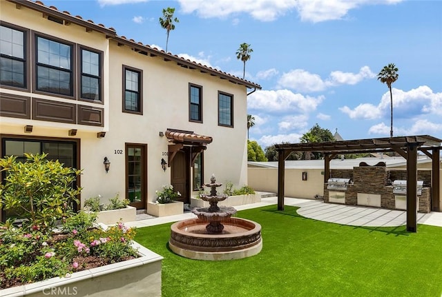 81 N Grand Oaks Ave Unit 102, Pasadena, CA 91107 - rear view of property featuring an outdoor kitchen, stucco siding, and a patio area