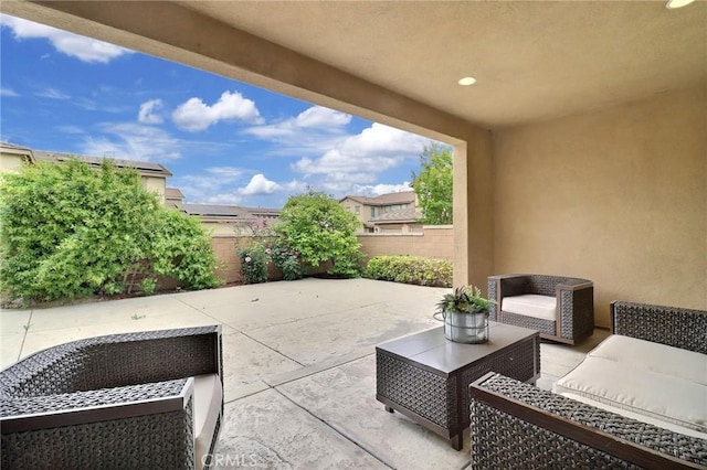 view of patio with an outdoor living space and a fenced backyard