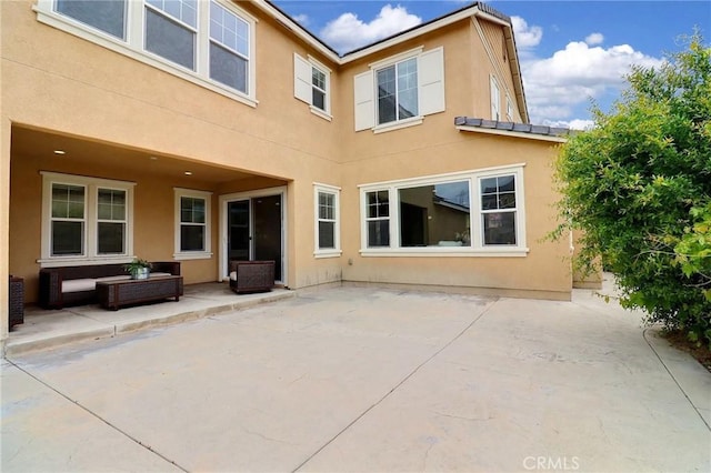 back of property featuring stucco siding and a patio area