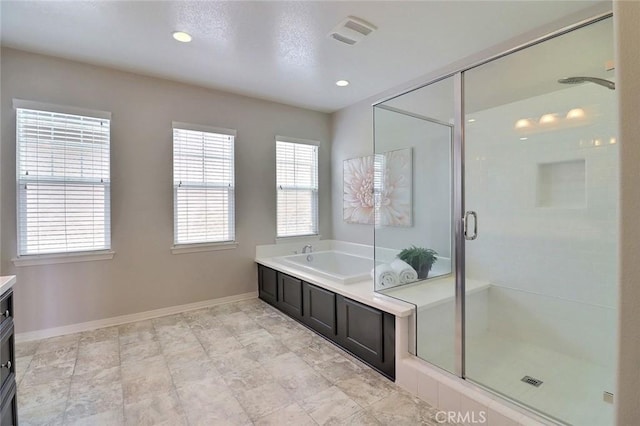 full bath featuring vanity, healthy amount of natural light, a shower stall, a bath, and recessed lighting