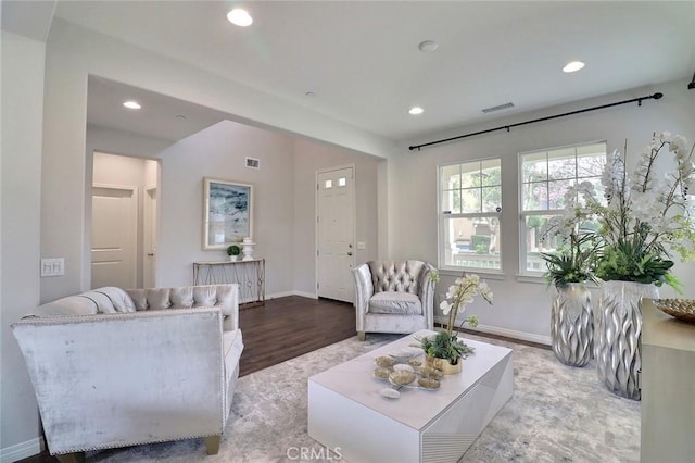 living area featuring recessed lighting, baseboards, and wood finished floors