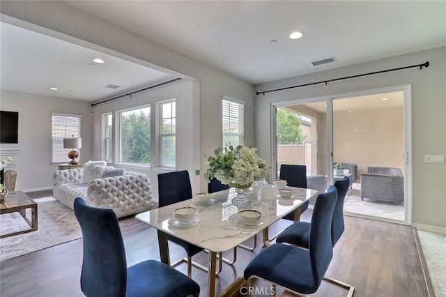 dining room featuring wood finished floors, baseboards, and recessed lighting