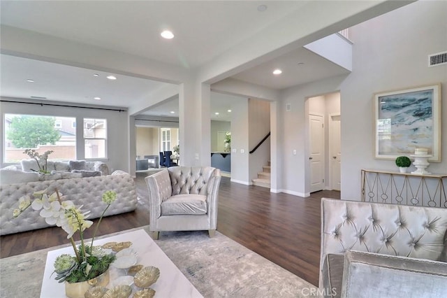 living area with wood finished floors, stairway, recessed lighting, and baseboards