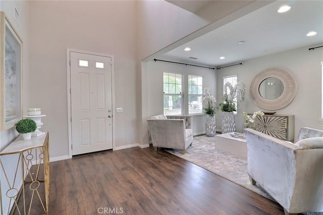 entryway featuring wood finished floors, baseboards, and recessed lighting