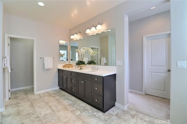 bathroom featuring double vanity and baseboards
