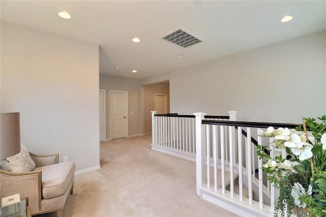living area featuring recessed lighting, light carpet, an upstairs landing, and baseboards