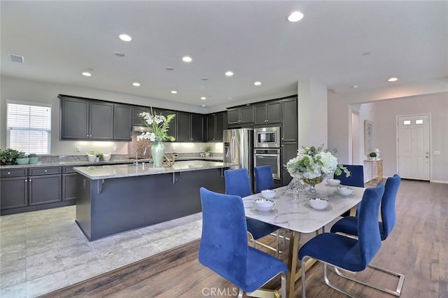 dining area featuring recessed lighting and light wood finished floors