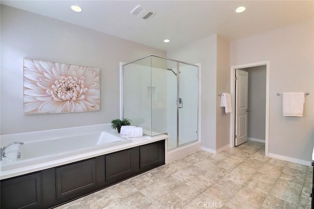 bathroom featuring a bath, a stall shower, recessed lighting, and baseboards
