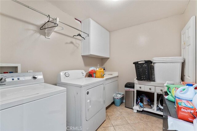 11874 Grayhawk Cir, Yucaipa, CA 92399 - clothes washing area featuring washer and dryer, cabinet space, and light tile patterned flooring