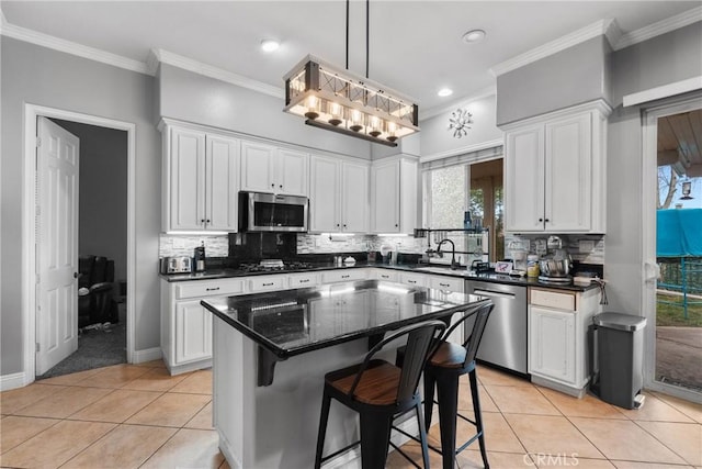 11874 Grayhawk Cir, Yucaipa, CA 92399 - kitchen with stainless steel appliances, light tile patterned flooring, white cabinets, crown molding, and recessed lighting