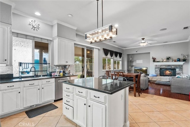 11874 Grayhawk Cir, Yucaipa, CA 92399 - kitchen featuring stainless steel dishwasher, light tile patterned floors, dark countertops, crown molding, and a sink