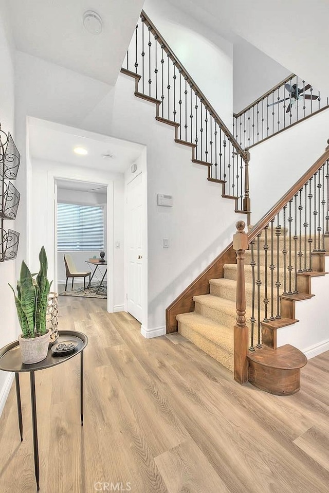 37089 Meadow Brook Way, Beaumont, CA 92223 - stairs featuring baseboards, wood finished floors, and a high ceiling