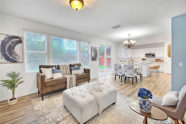 37089 Meadow Brook Way, Beaumont, CA 92223 - living room featuring a chandelier, light wood-style flooring, baseboards, and recessed lighting
