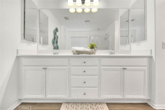 37089 Meadow Brook Way, Beaumont, CA 92223 - bathroom featuring double vanity, wood finished floors, a shower stall, and baseboards