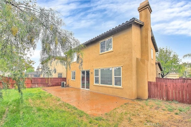 37089 Meadow Brook Way, Beaumont, CA 92223 - back of house with a patio area, a chimney, stucco siding, and central AC