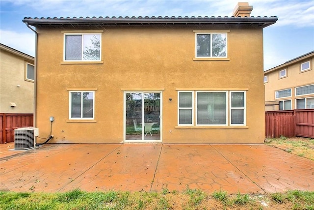 37089 Meadow Brook Way, Beaumont, CA 92223 - rear view of house featuring stucco siding, central AC unit, fence, and a chimney