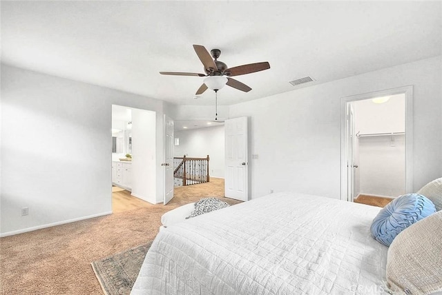 37089 Meadow Brook Way, Beaumont, CA 92223 - bedroom featuring light colored carpet, baseboards, a spacious closet, a ceiling fan, and connected bathroom