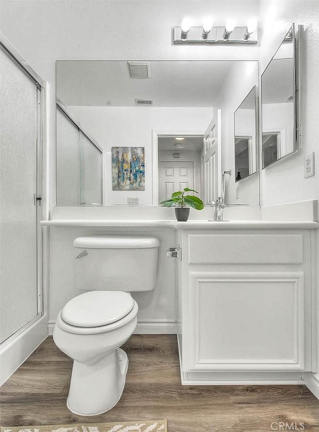 37089 Meadow Brook Way, Beaumont, CA 92223 - bathroom featuring a shower stall, vanity, toilet, and wood finished floors
