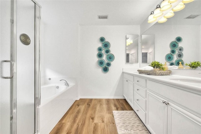 37089 Meadow Brook Way, Beaumont, CA 92223 - bathroom featuring a shower stall, double vanity, a bath, and wood finished floors