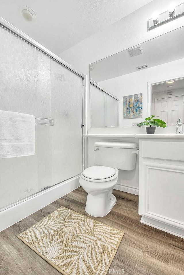 37089 Meadow Brook Way, Beaumont, CA 92223 - bathroom featuring toilet, a shower stall, vanity, and wood finished floors