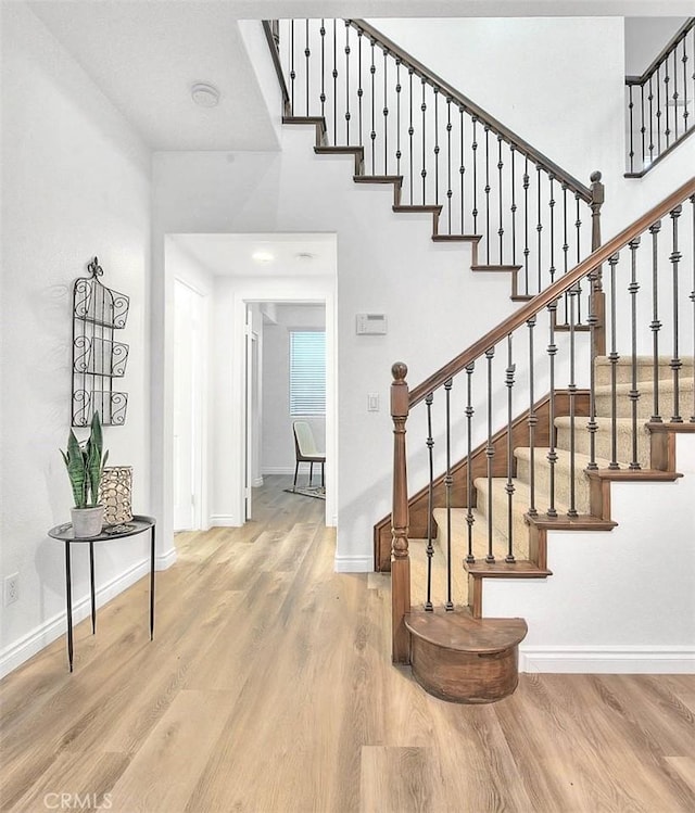 37089 Meadow Brook Way, Beaumont, CA 92223 - staircase with wood finished floors and baseboards