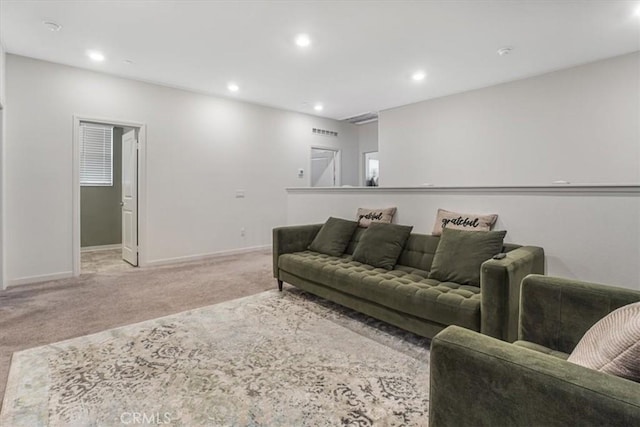carpeted living room with recessed lighting and baseboards