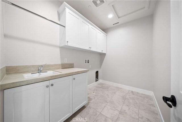 laundry area featuring attic access, washer hookup, cabinet space, baseboards, and electric dryer hookup