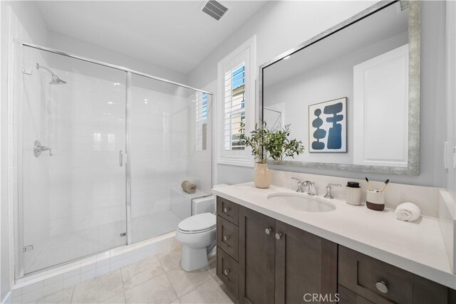 bathroom with toilet, a stall shower, and vanity