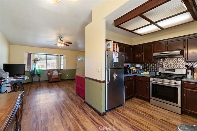 1451 Segovia Ct, Madera, CA 93638 - kitchen with appliances with stainless steel finishes, under cabinet range hood, ceiling fan, wood finished floors, and dark brown cabinetry