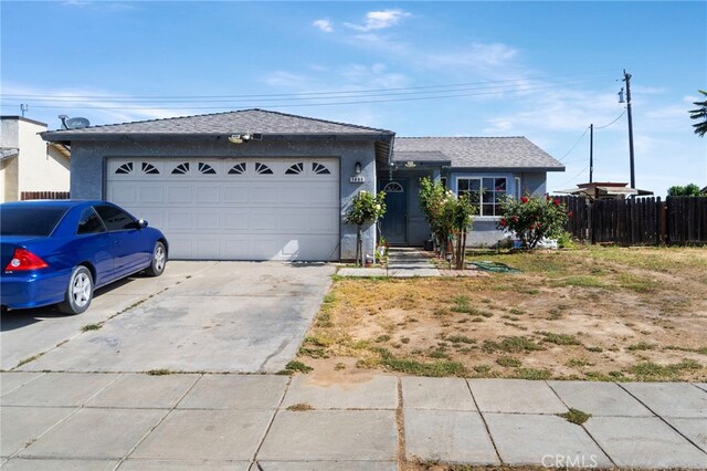 1451 Segovia Ct, Madera, CA 93638 - single story home with a garage, driveway, fence, and stucco siding