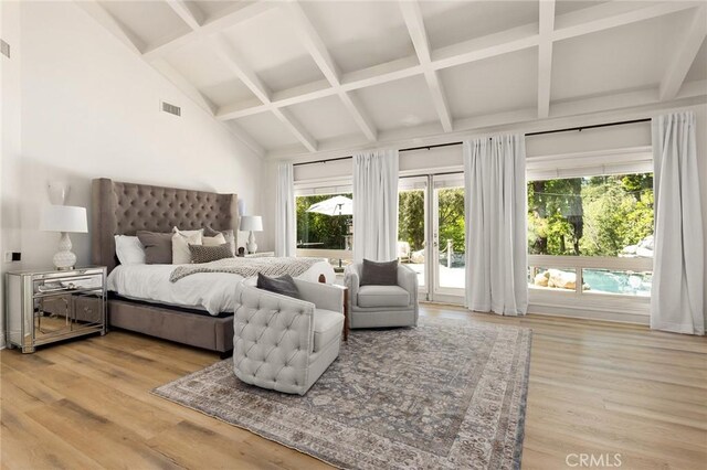 bedroom with access to exterior, light wood finished floors, beam ceiling, and coffered ceiling