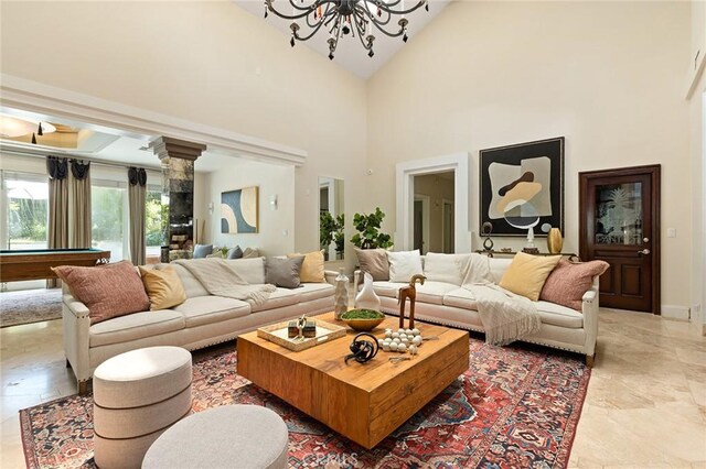 living room with high vaulted ceiling, a chandelier, pool table, and baseboards