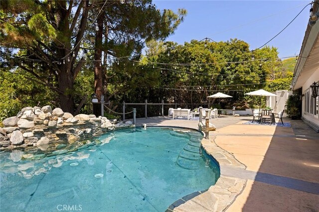 view of swimming pool with a patio area