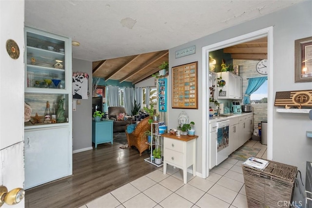 2785 Solana Way, Laguna Beach, CA 92651 - kitchen featuring light countertops, white cabinets, light tile patterned floors, dishwasher, and vaulted ceiling