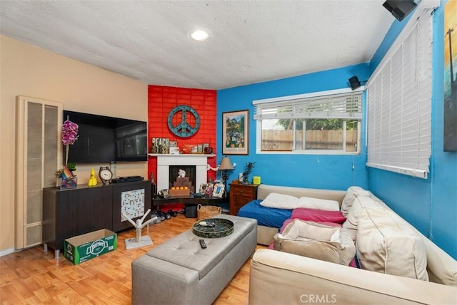 living area with a textured ceiling and wood finished floors