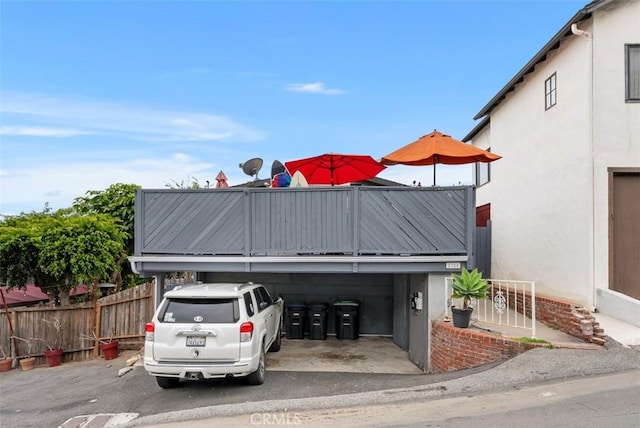 view of vehicle parking featuring fence