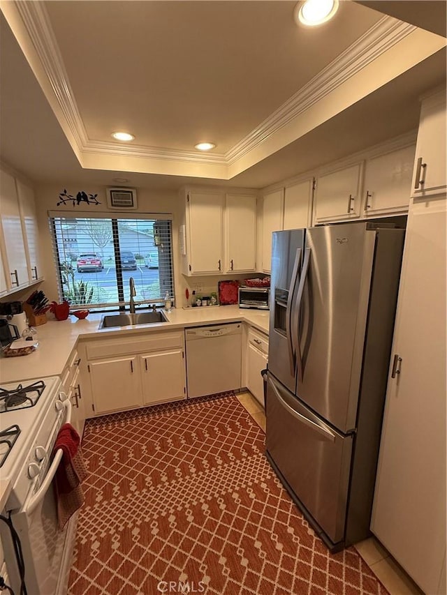 8566 Fallbrook Cir Unit C704B, Huntington Beach, CA 92646 - kitchen featuring white appliances, a sink, a raised ceiling, light countertops, and crown molding