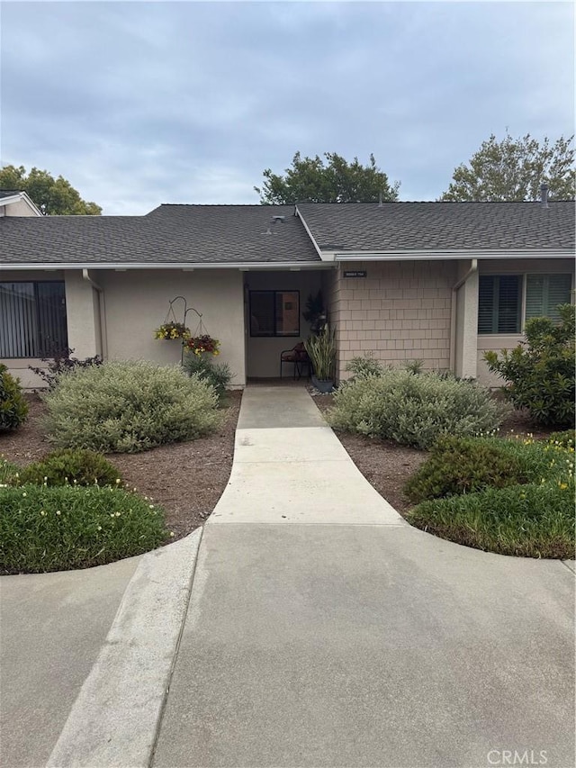8566 Fallbrook Cir Unit C704B, Huntington Beach, CA 92646 - doorway to property with a shingled roof