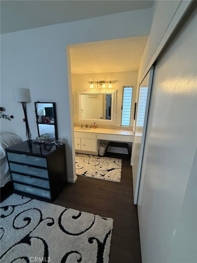 8566 Fallbrook Cir Unit C704B, Huntington Beach, CA 92646 - bedroom featuring a sink, wood finished floors, ensuite bath, and an office area
