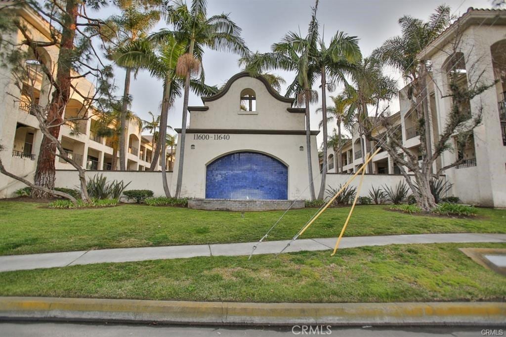 11620 Warner Ave Unit 423, Fountain Valley, CA 92708 - view of front of house with stucco siding and a front lawn