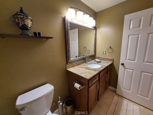 half bath featuring vanity, toilet, and tile patterned floors