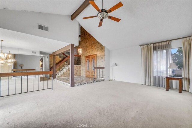 unfurnished living room with high vaulted ceiling, carpet flooring, stairway, beam ceiling, and a ceiling fan