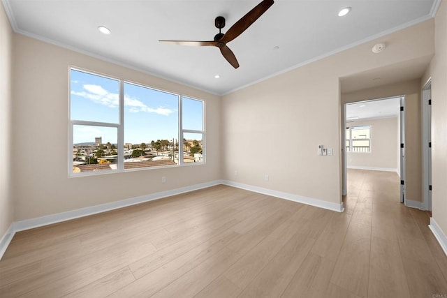 spare room featuring ceiling fan, ornamental molding, light wood-style floors, baseboards, and recessed lighting