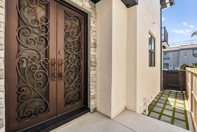 entrance to property with stone siding and stucco siding