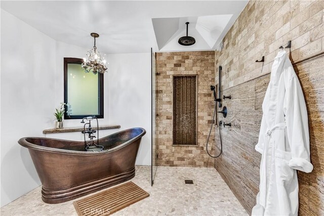 full bathroom featuring tiled shower, a soaking tub, and a chandelier