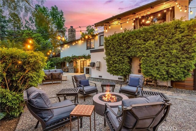 view of patio featuring an outdoor living space with a fire pit